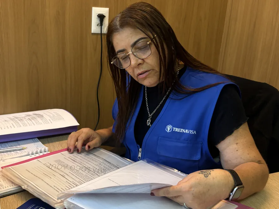 Ana Roberta analisando documentos de um estabelecimento